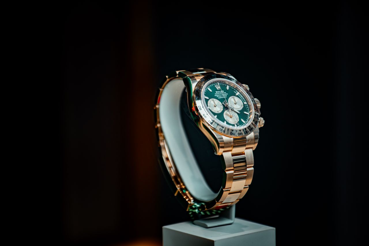 gallery-5 Stunning emerald green and gold luxury watch displayed elegantly against a dark background.